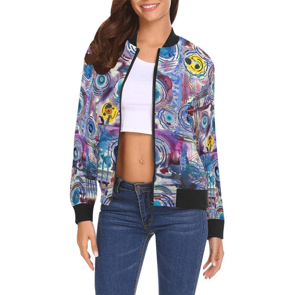 Woman wearing Circles on Water all over print bomber jacket with colorful abstract circular water ripple design, black ribbed collar, cuffs, and hem, paired with white crop top and blue jeans