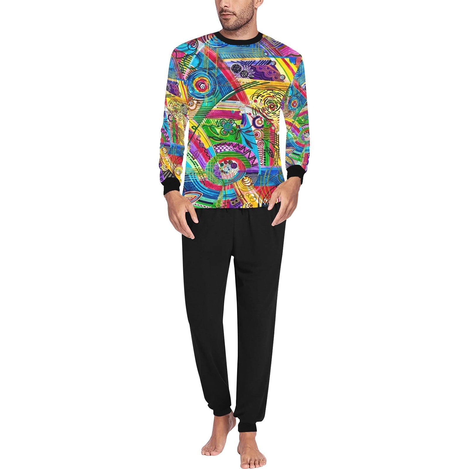 Man wearing playful men's PJ set with colorful long sleeve top and black relaxed fit trousers.