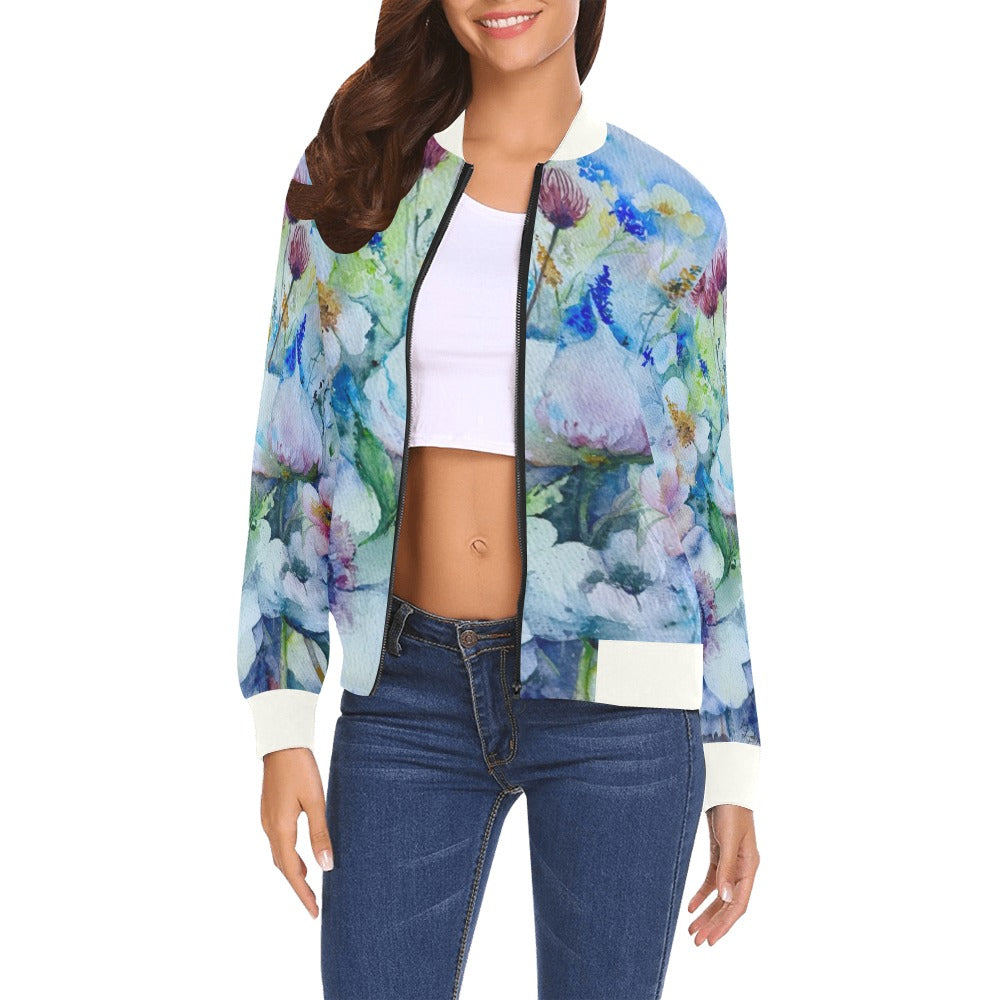 Woman wearing a Flower Fantasy Bomber Jacket with watercolor floral design, white ribbed collar and cuffs, paired with jeans and a white crop top
