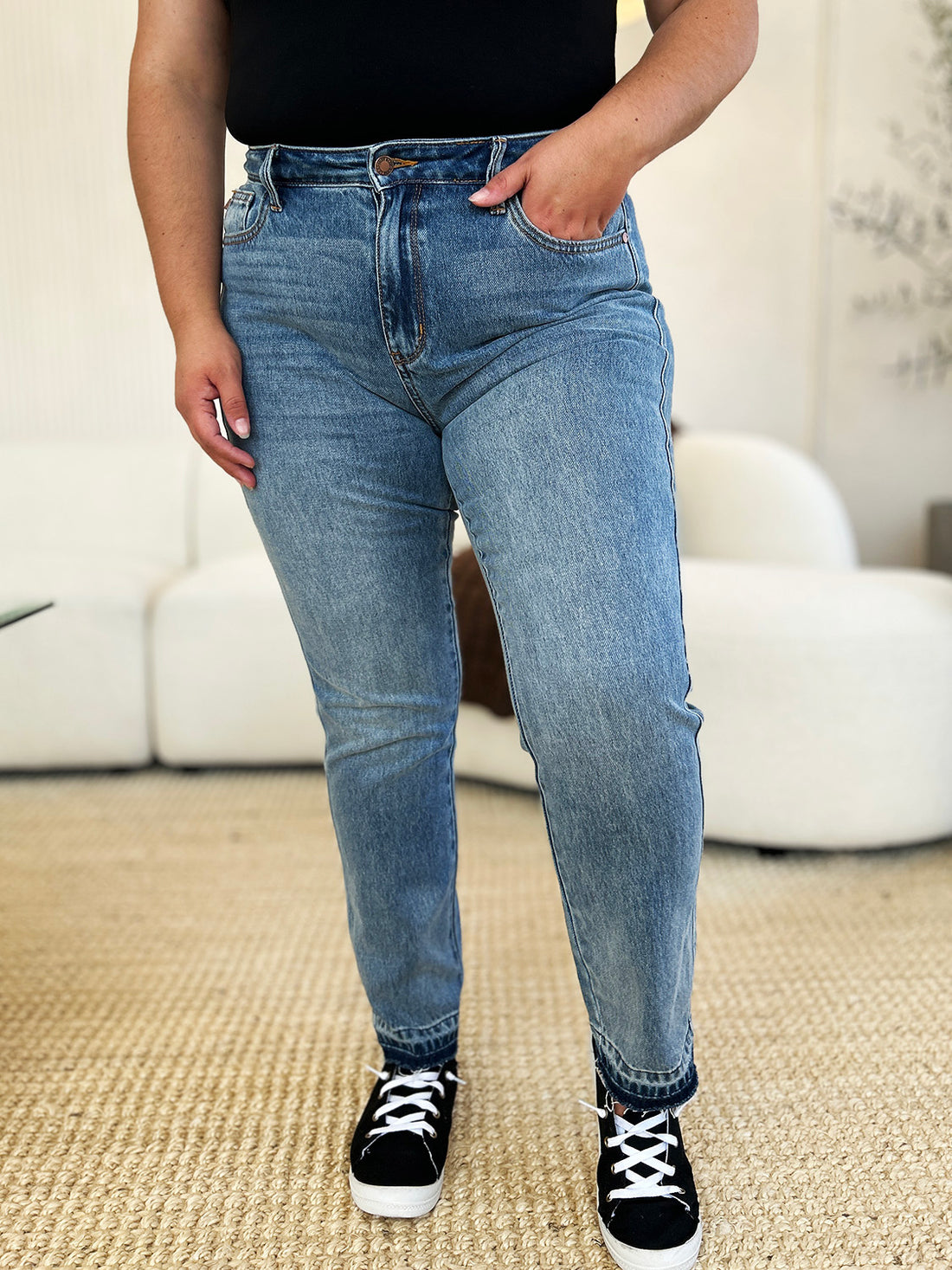 Judy Blue full size mid rise rigid blue jeans with magic release hem and moderate stretch worn with black sneakers
