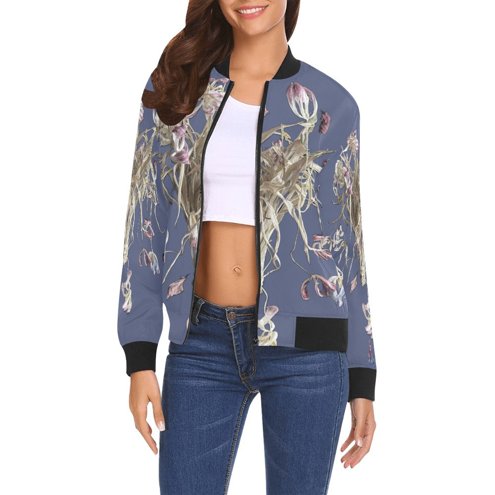 Woman wearing Tulip Drama Marlin Bomber Jacket with floral artwork on blue background and black ribbed collar, cuffs, and hem
