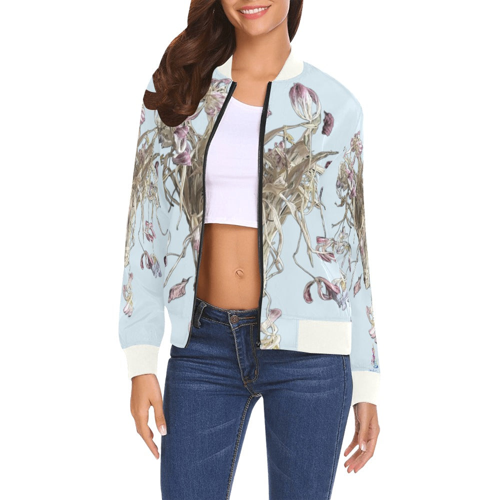 Woman wearing a Celestial Bomber Jacket with floral artwork, zip-up front, ribbed collar and cuffs, paired with jeans and a white crop top