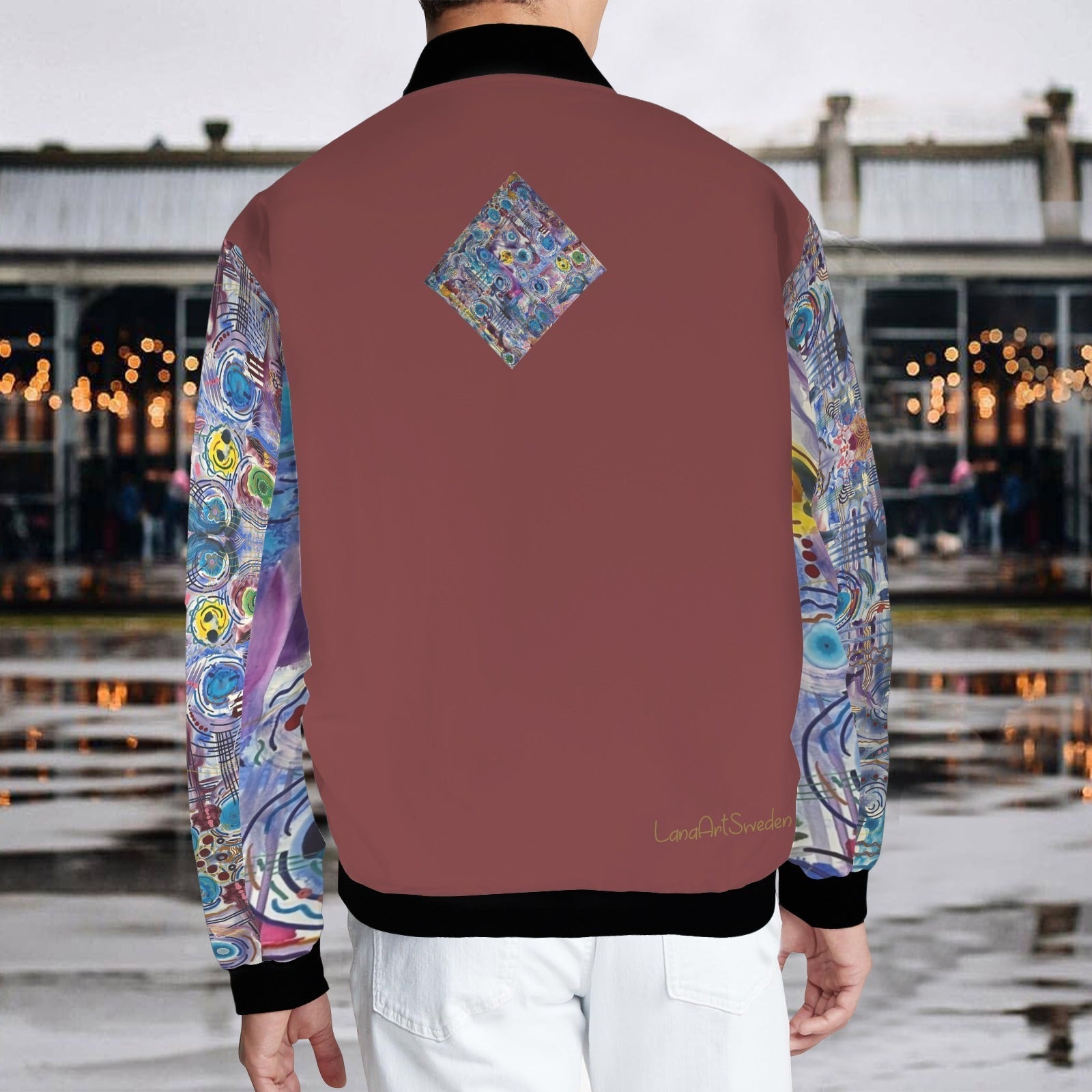 Back view of Circles on Water Burgundy bomber jacket with colorful abstract patterned sleeves and diamond design on burgundy back.