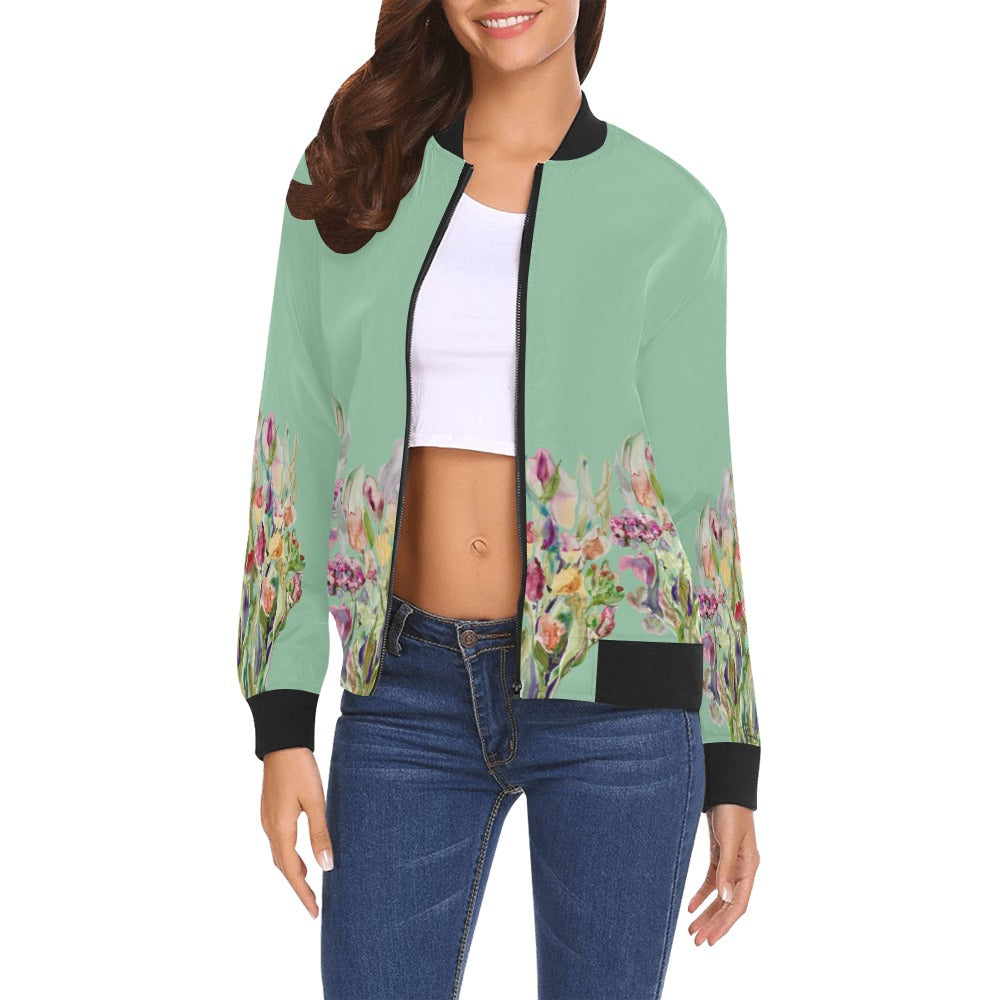 Woman wearing Rusty Life Bomber Jacket with floral artwork by LanaArtSweden, green base, black ribbed collar, cuffs, and hem