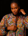 Woman wearing colorful Fall Fiesta Warm Bomber Jacket with vibrant autumn-inspired patterns