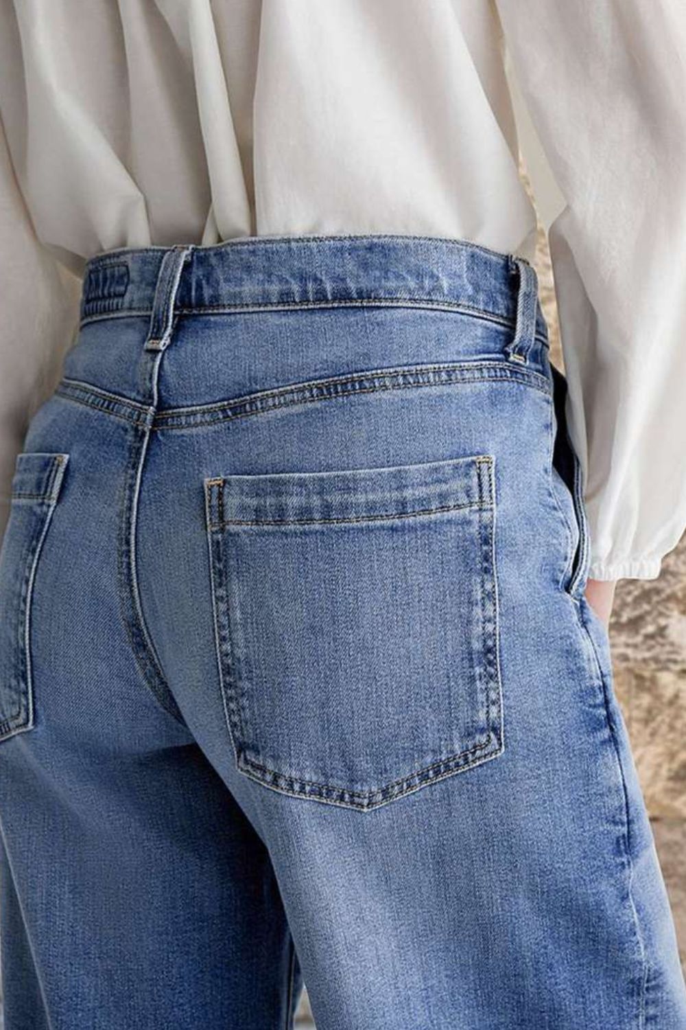 Pocketed embroidered straight leg jeans in blue denim with brown belt and casual footwear