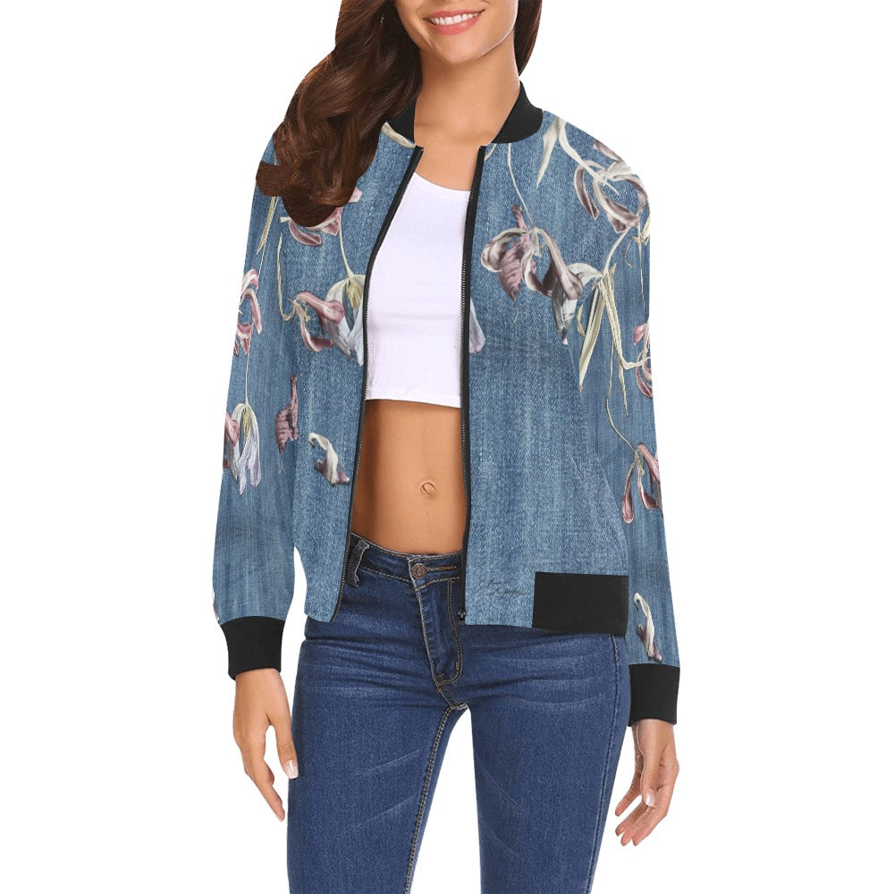 Woman wearing a denim tulips bomber jacket with ribbed cuffs and collar, paired with a white crop top and jeans
