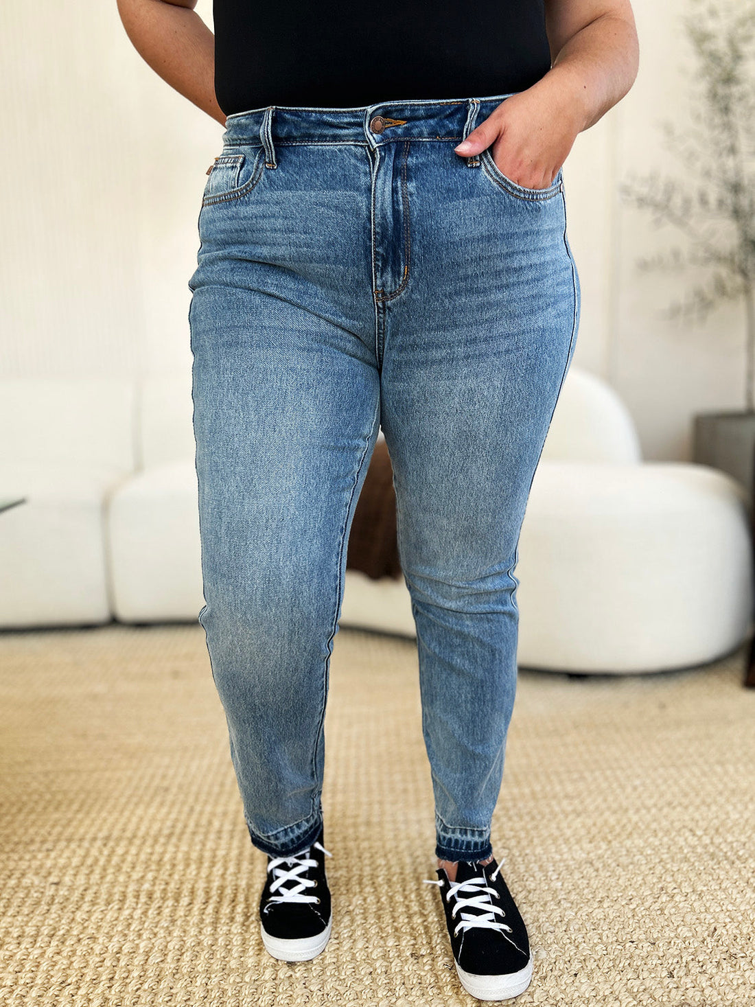 Judy Blue full size mid rise rigid blue jeans with magic release hem and moderate stretch worn with black sneakers