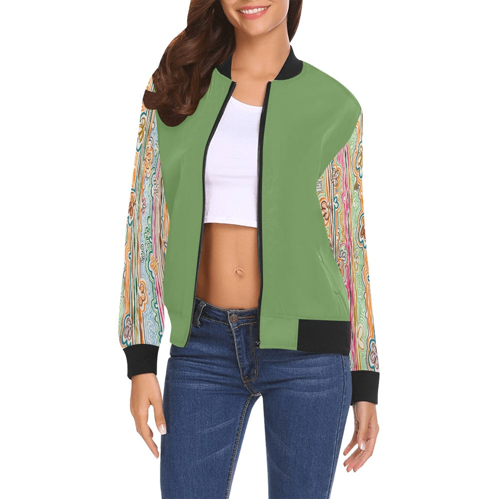 Woman wearing a green bomber jacket with colorful Spring Fever Sleeves pattern, black collar and cuffs, paired with a white crop top and blue jeans.