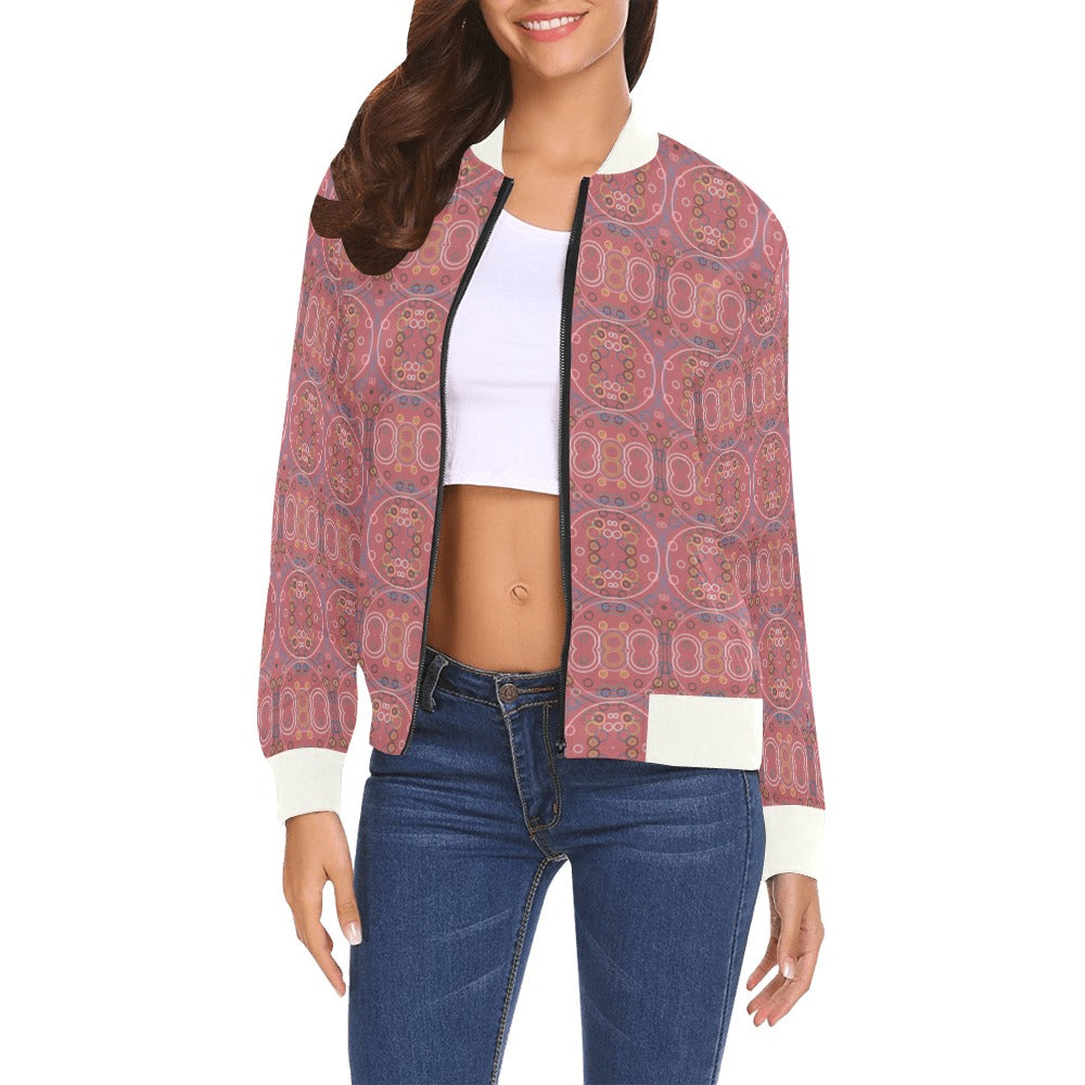 Woman wearing old rose city bomber jacket with artistic circular patterns and white ribbed collar, cuffs, and hem.